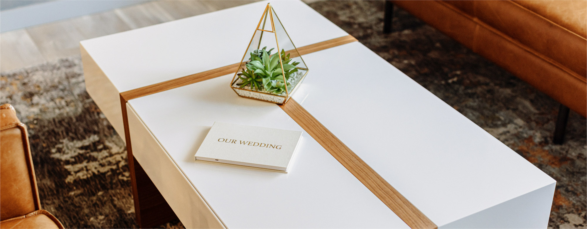 The Motion Books Wedding Video Album laying on a coffee table - The perfect coffee table video book that plays your wedding film.