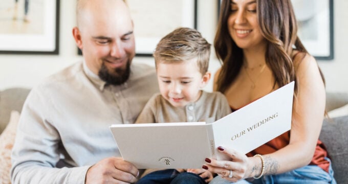 A Family looking at a Wedding Video Album